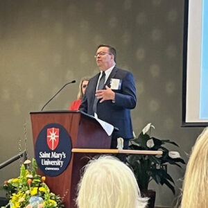 Scott Becker speaking in front of a group of students at St. Mary's University in Minnesota.